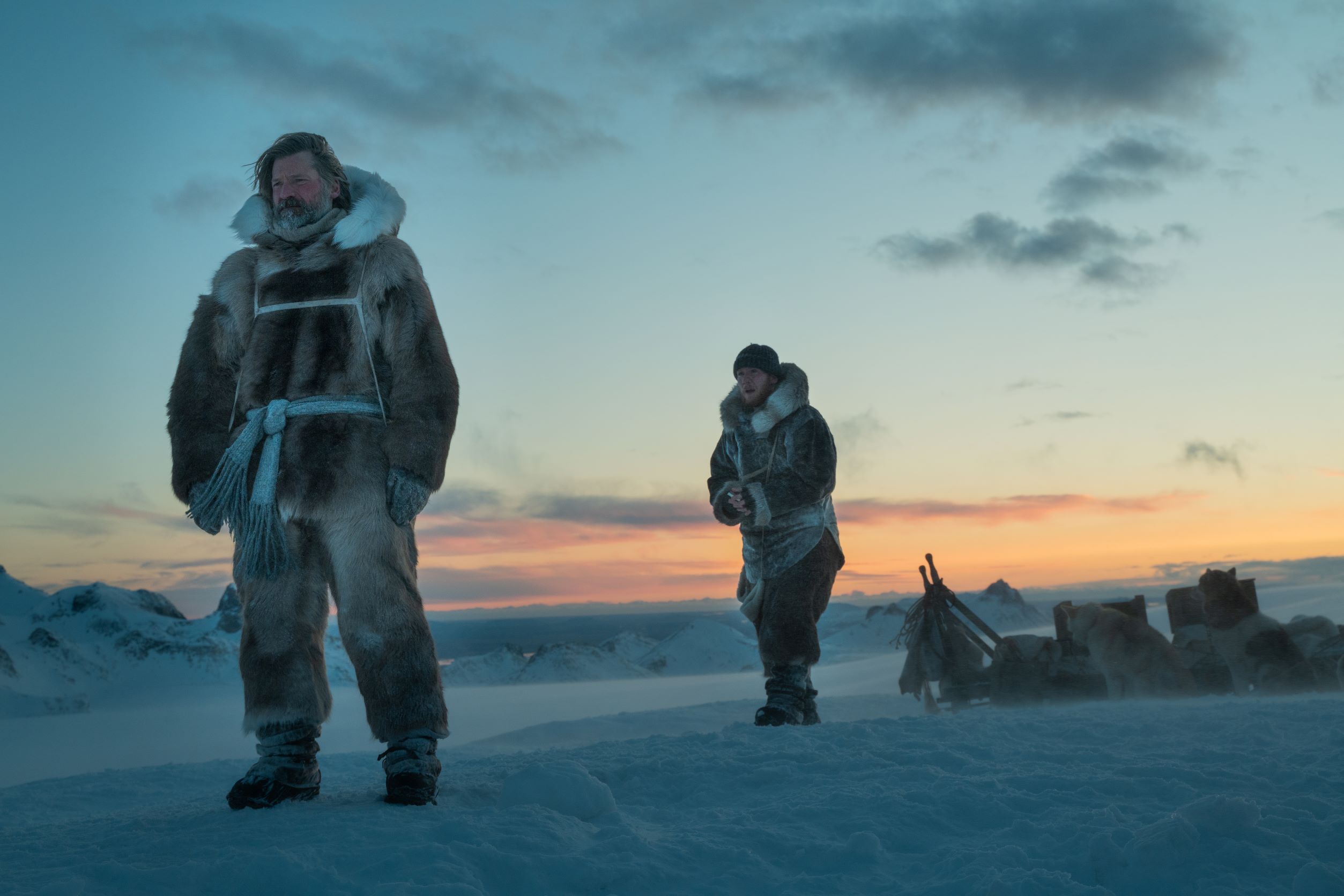 Image from 'Against the Ice' movie: actors Nikolaj Coster-Waldau and Joe Cole in a scene in the mountains and snow of Greenland.