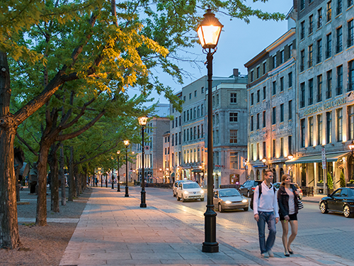 A couple walk down the street on an evening in Montreal, Canada