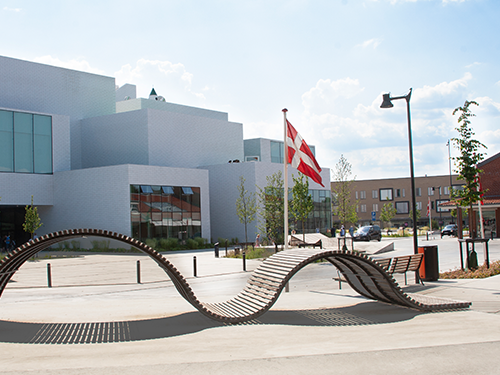 The exterior of the Lego House in Billund, Denmark, with the Danish flag in shot