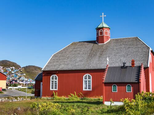 a brightly painted red historic church in Qaqortoq, Greenland