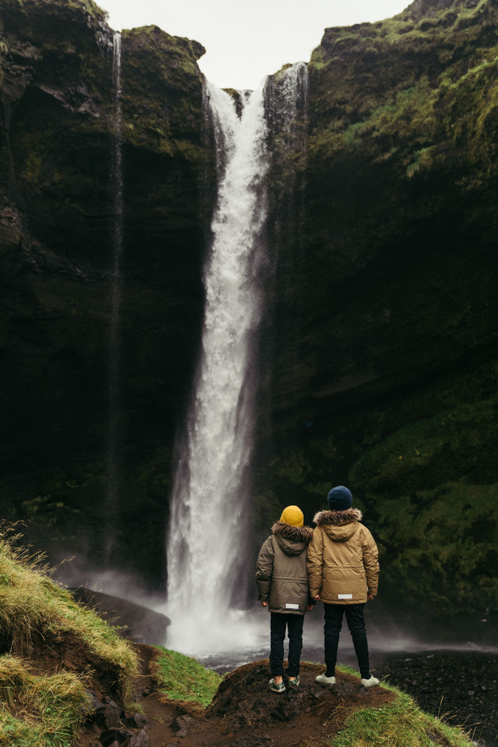 Chris Burkard's 2 sons gazing at Kvernufoss waterfall