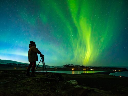 a photographer capturing the northern lights