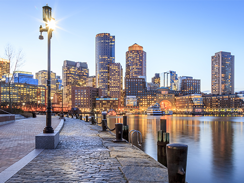 A street scene in Boston with the harbour basking in evening light