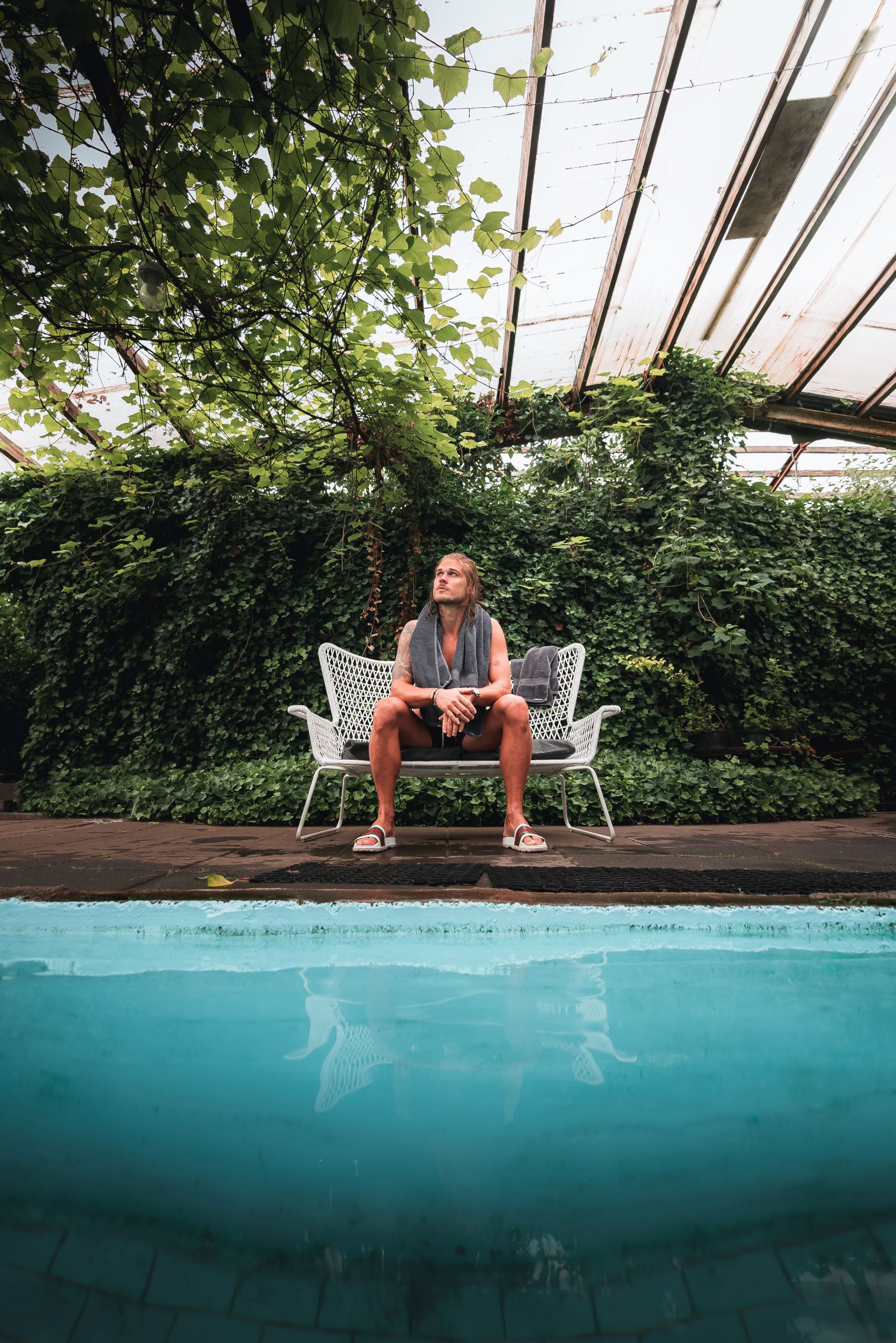 Rurik Gislason sits beside an indoor pool at Heydalur farm in the Westfjords
