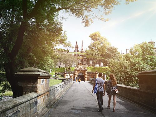 A couple hold hands as they walk through a public park in Glasgow, Scotland