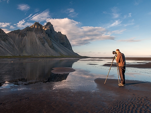 a photographer capturing Vestrahorn mountain