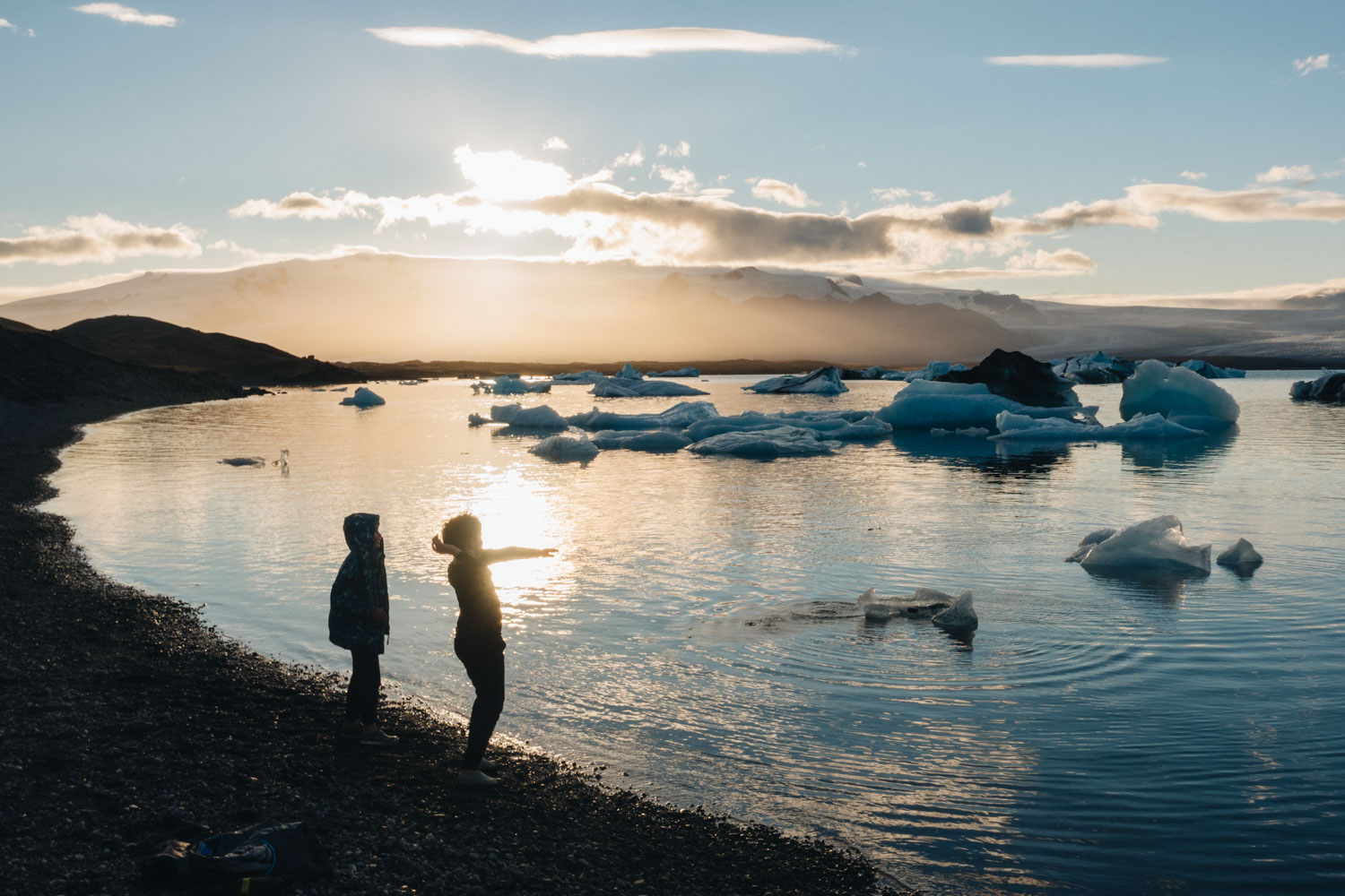 Chris Burkard's 2 sons at sunset on the edge of the glacier lagoon, Jökulsárlón, in southeast Iceland