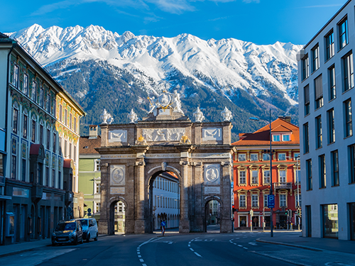 A beautiful gate positioned downtown in Innsbruck with a range of bus, bike, car and pedestrian routes.