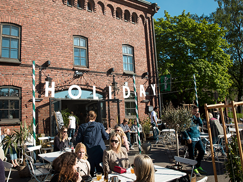 People relax outside a dining establishment in Helsinki, Finland 