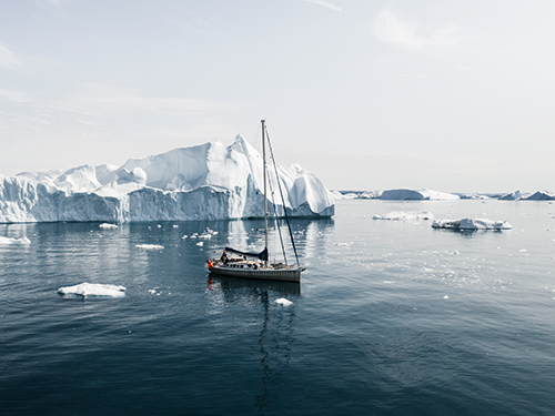 A sail boat is pictured among the ice bergs at Disko Bay in Ilulissat, Greenland 