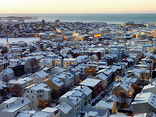 An overhead view of Reykjavík on a cold winter day, where the rooftops are covered in snow