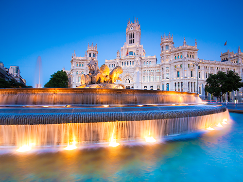 The fountain at Plaza de Cibeles in Madrid, Spain, lit up in early morning light 