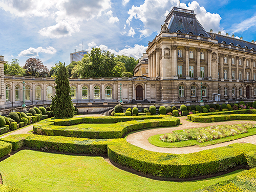 The Royal Palace of Brussels pictured on a bright sunny day with the hedge garden in shot 