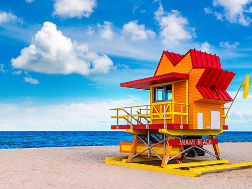 a bright yellow lifeguard shelter on Miami beach