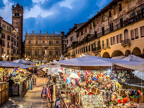 The lively market at Piazza delle Erbe in Verona, pictured here at night