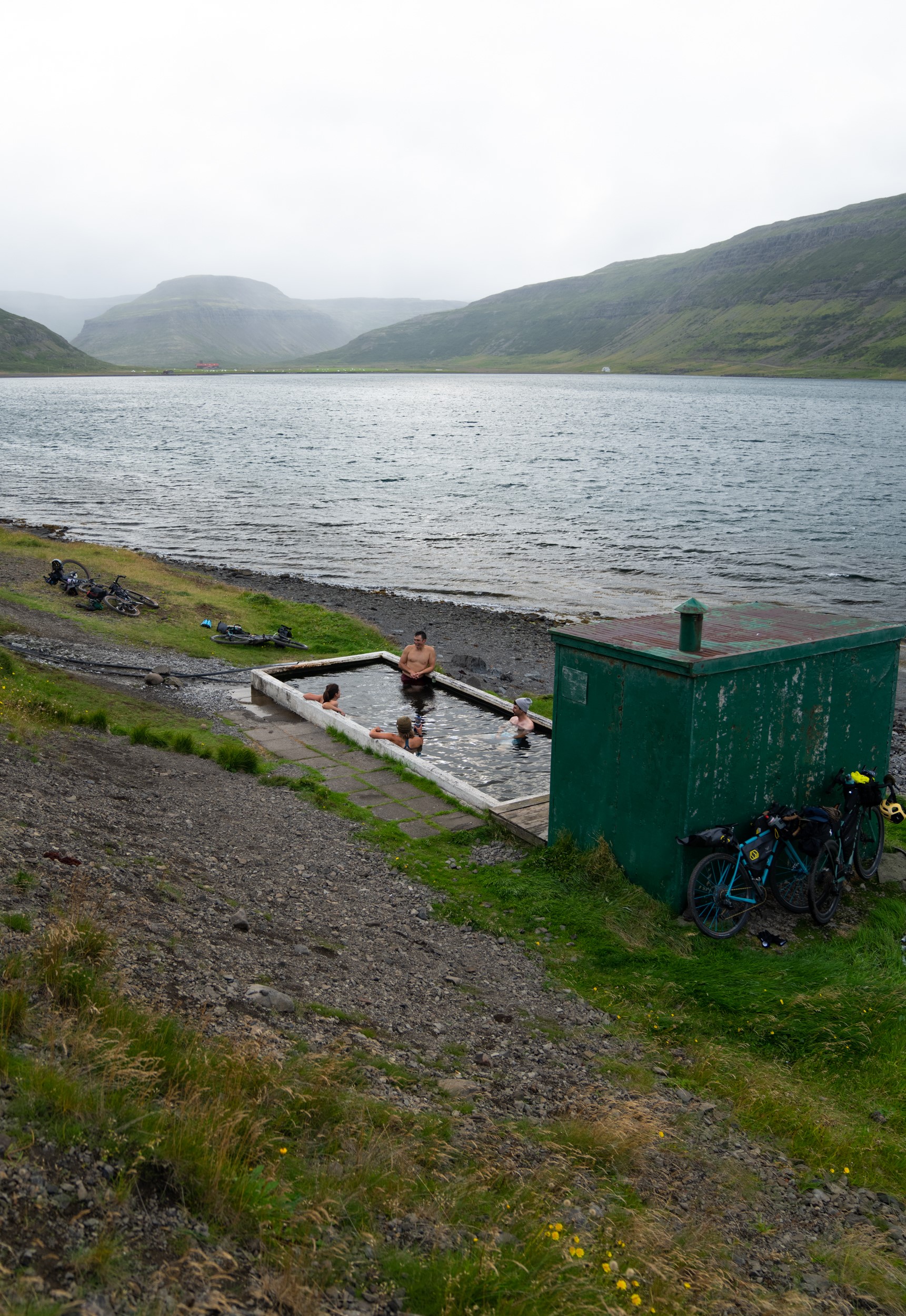 Chris Burkard and his team relax in the Hörgshlíðarlaug hot spring