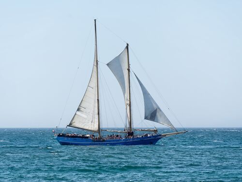 a sailboat sits off the coast of Portugal