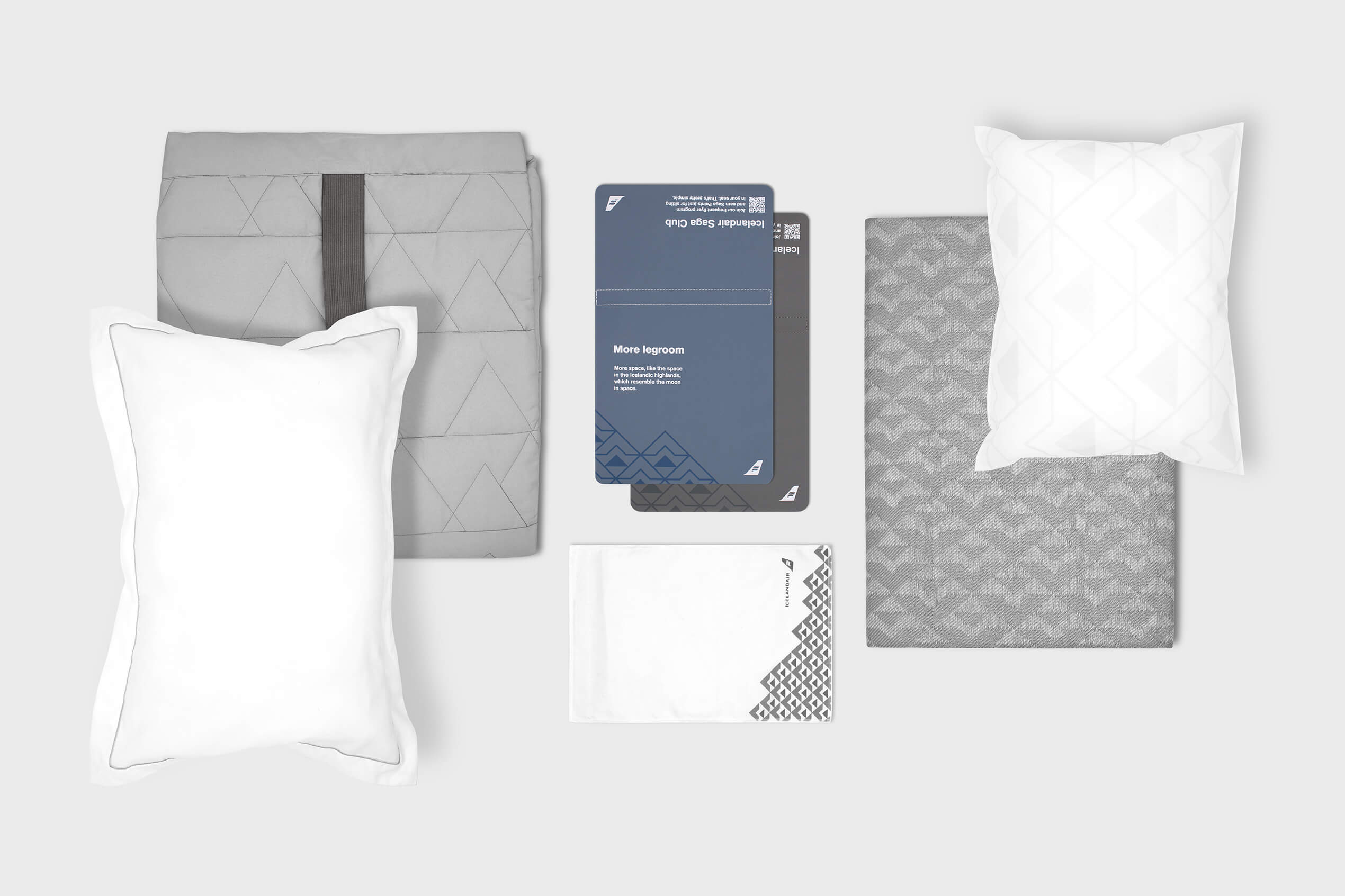 The new Icelandair textile collection showing pillows, blankets and more in a grey and white colour pallette