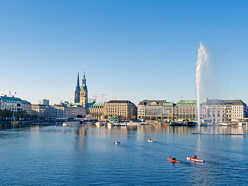 A view of the waterfront in Hamburg on a bright blue clear sky day