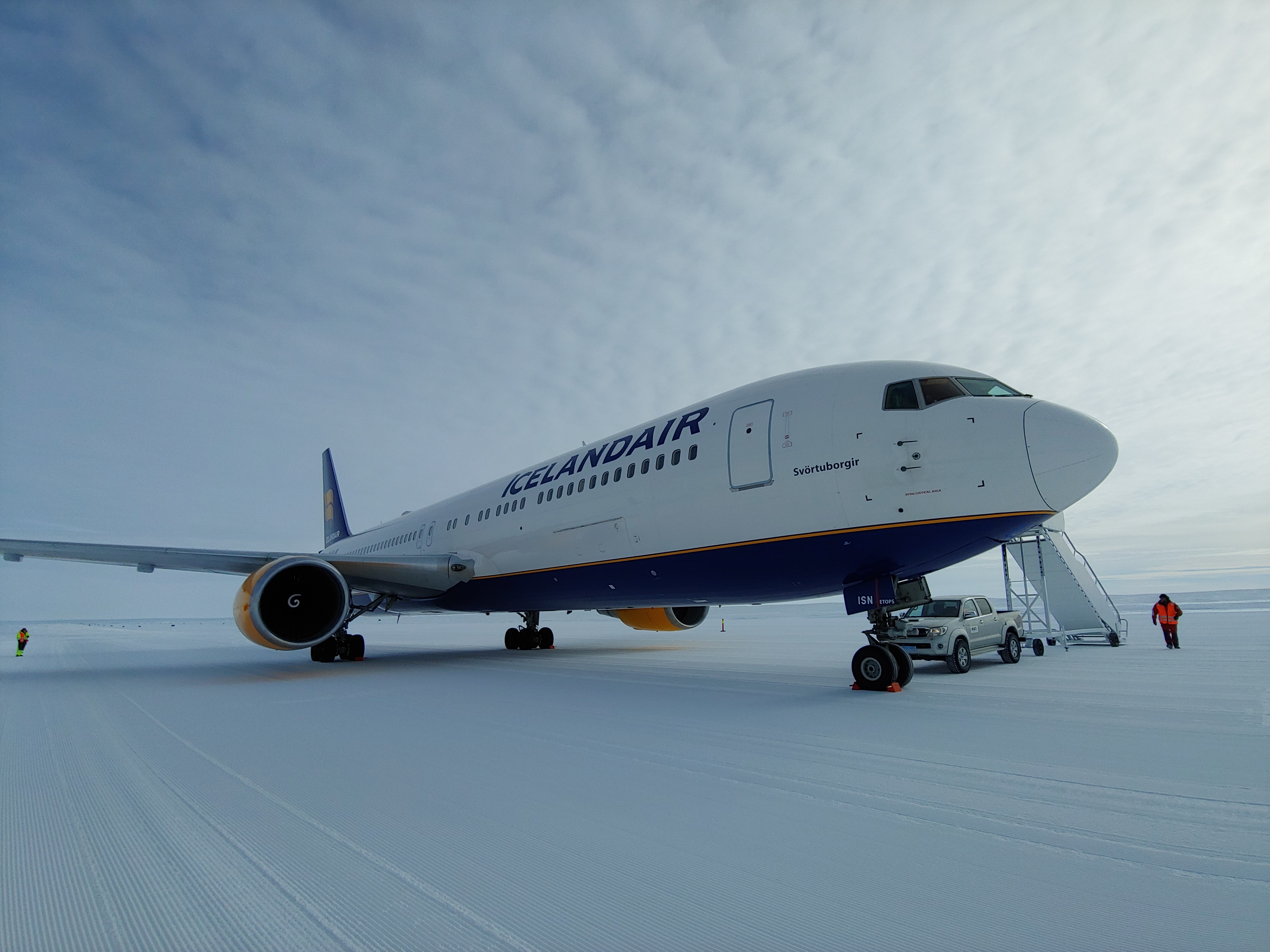 The Icelandair aircraft stationary with the stairs down, pictured on a snowy runway in Antarctica