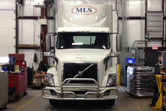 An MLS tractor parked inside a maintenance bay at an MLS facility