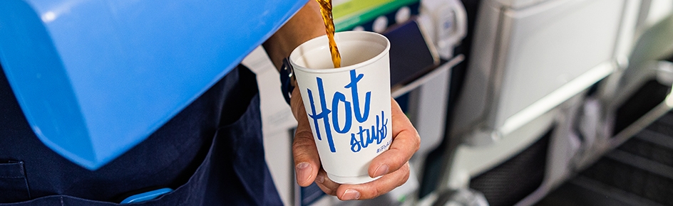 Passenger being served hot coffee