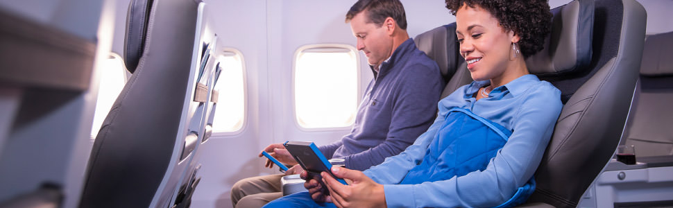 Woman looking at a tablet in first class.