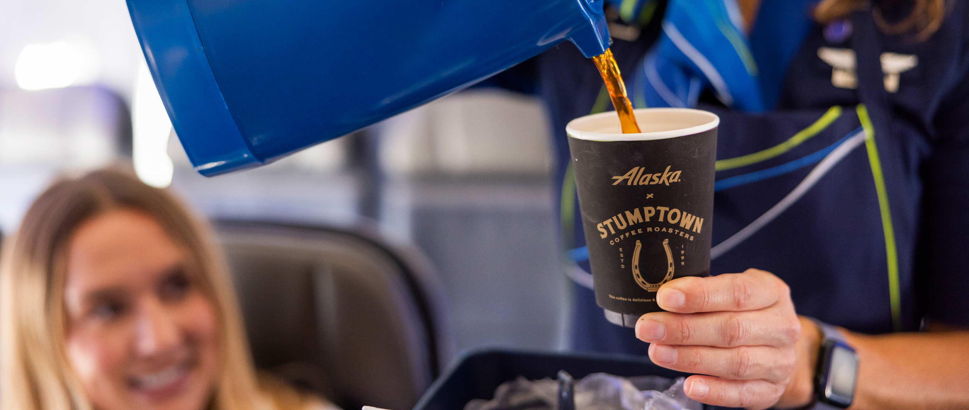 Passenger being served hot coffee