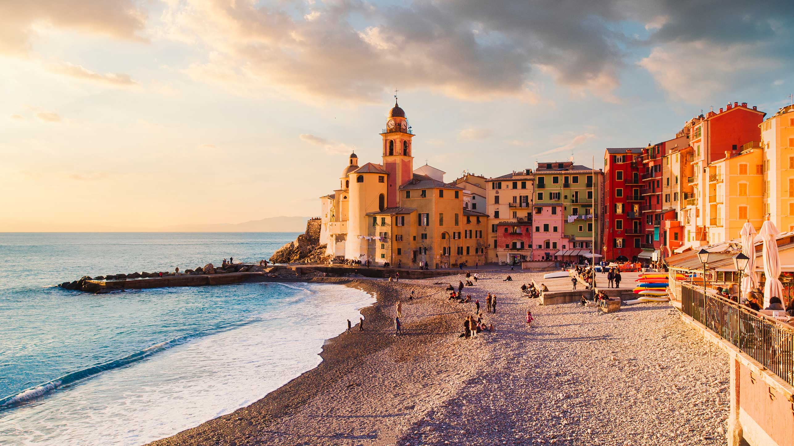 Photo of the Italian Riviera Coast with colorful buildings and a beach
