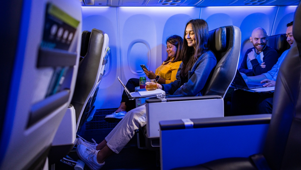 Woman stretched out and enjoying first class legroom.