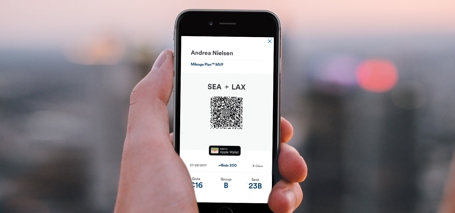 A picture of a person using a boarding pass that is on their phone.