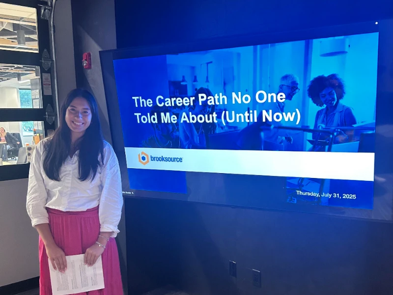 altman summer scholars student mia standing in front of her presentation