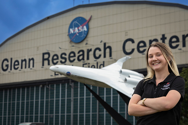 Miami student poses in front of the NASA Glenn Research Center.