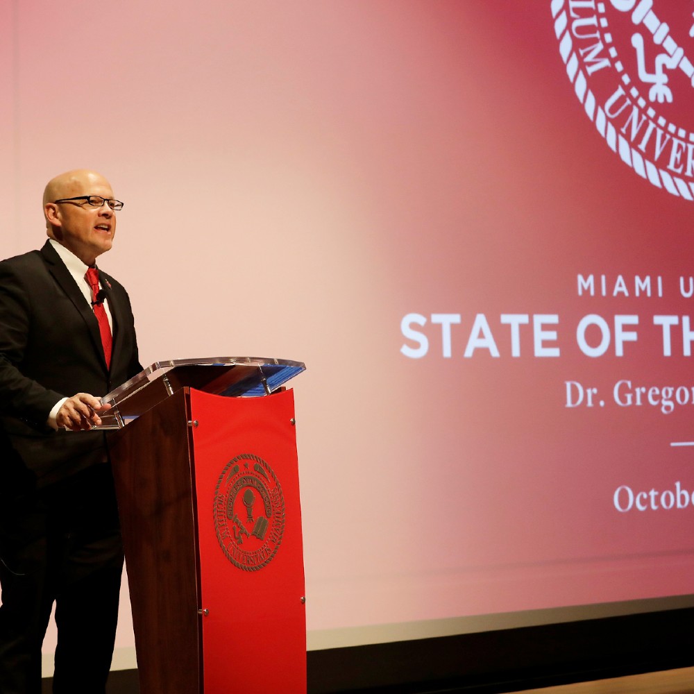 President Crawford speaks from a podium.