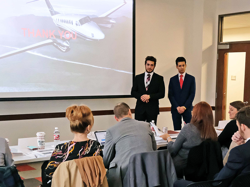 Two students making a business presentation to the class.