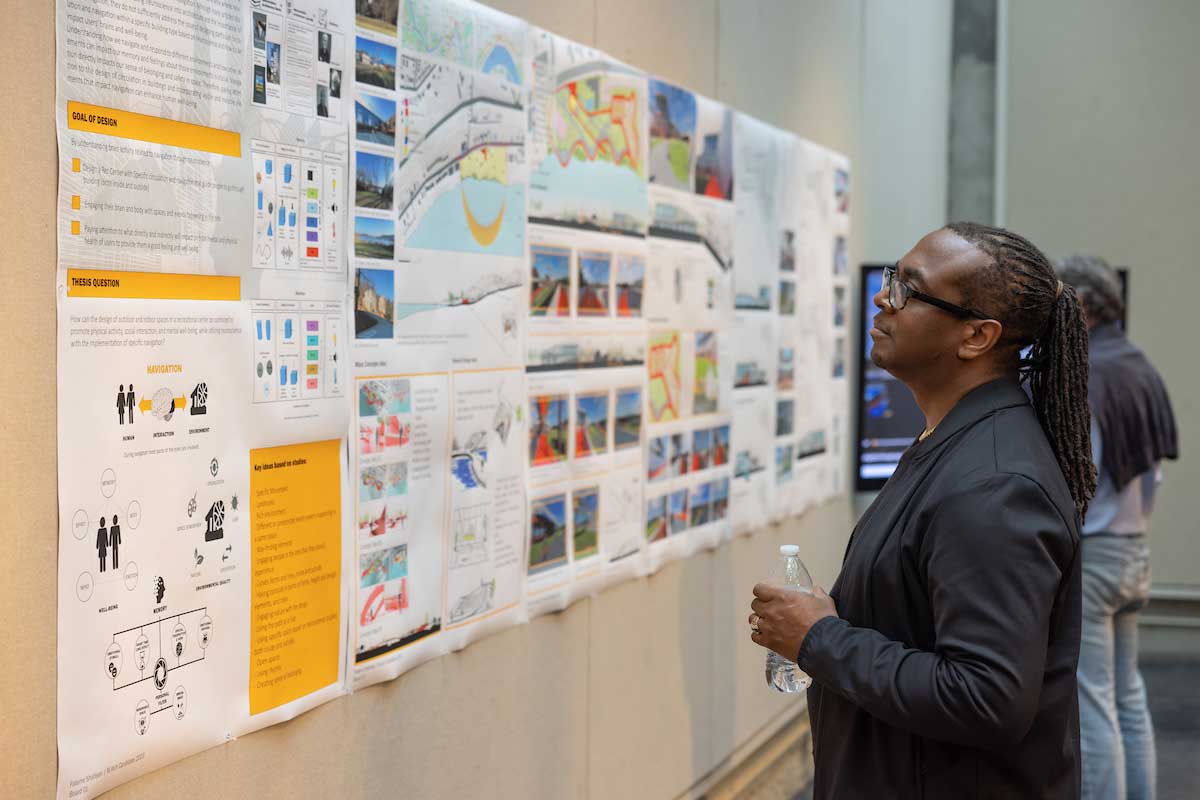 grad student viewing presentation poster