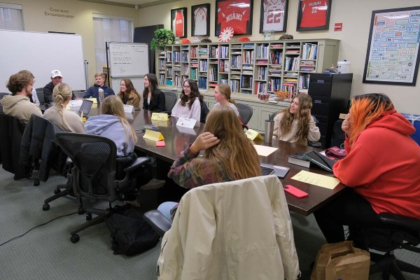 group of students at the center for kickglass change working on a project around a table