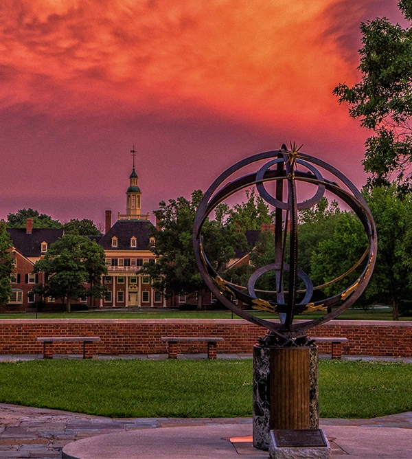 vibrant orange sunset over campus and the sundial
