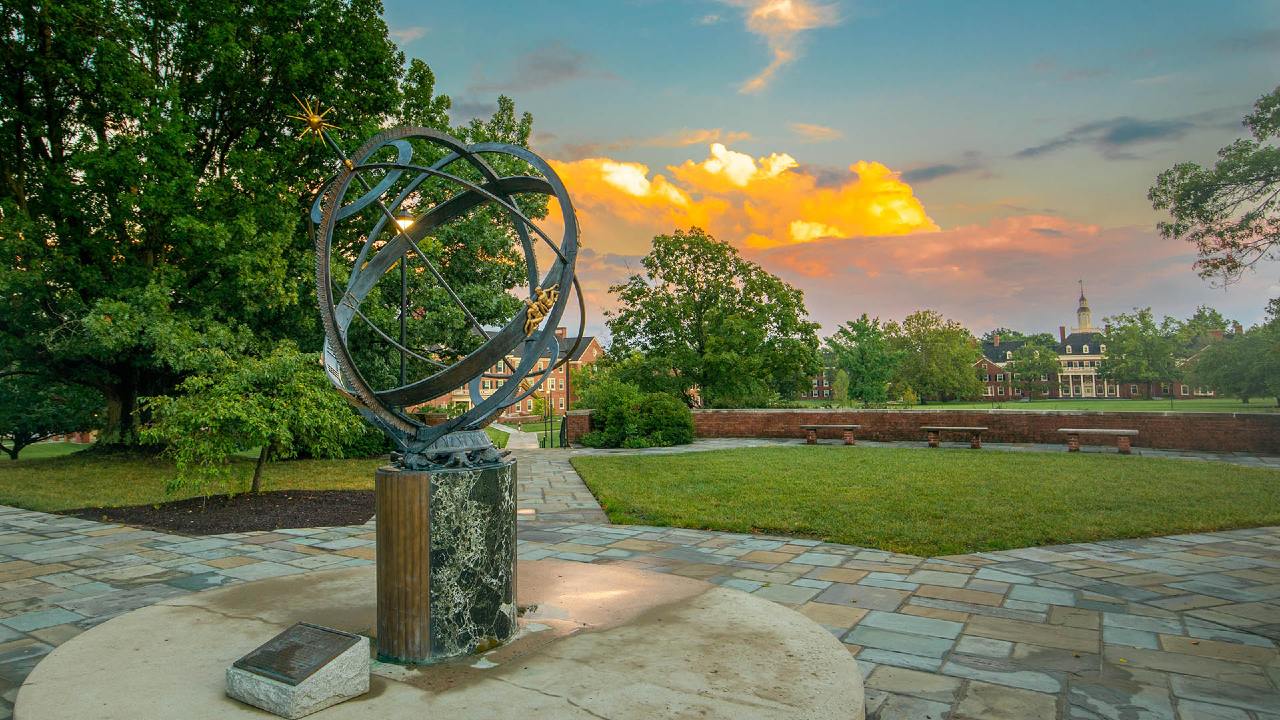 View of the sundial overlooking MacCracken Hall on the Oxford campus during a vivid blue and orange sunset