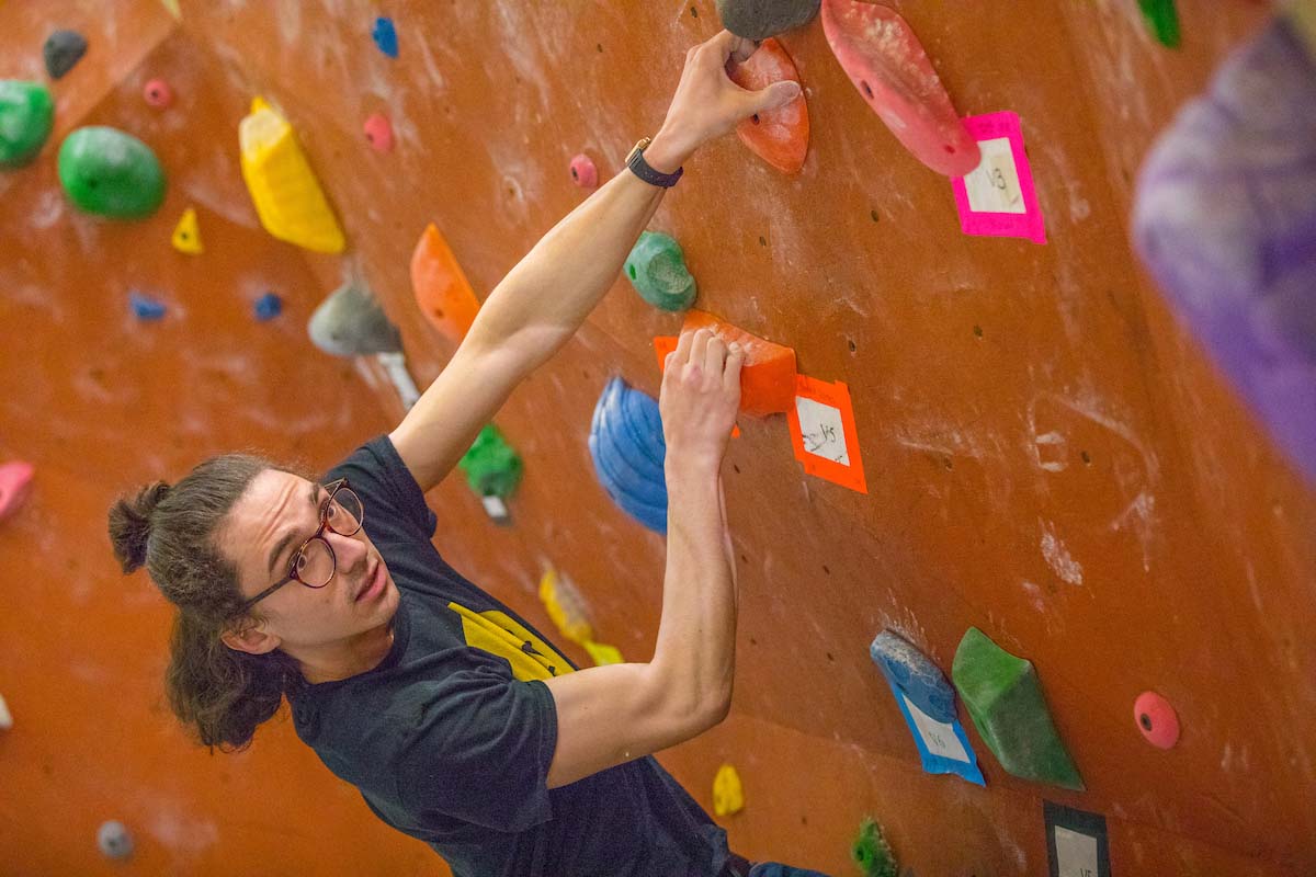 A student climbing the rock wall at Miami's Outdoor Pursuit Center.
