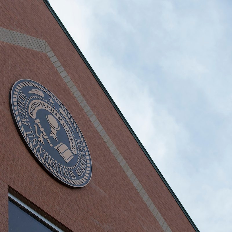 The Miami University seal displayed prominently on a Regionals campus building.