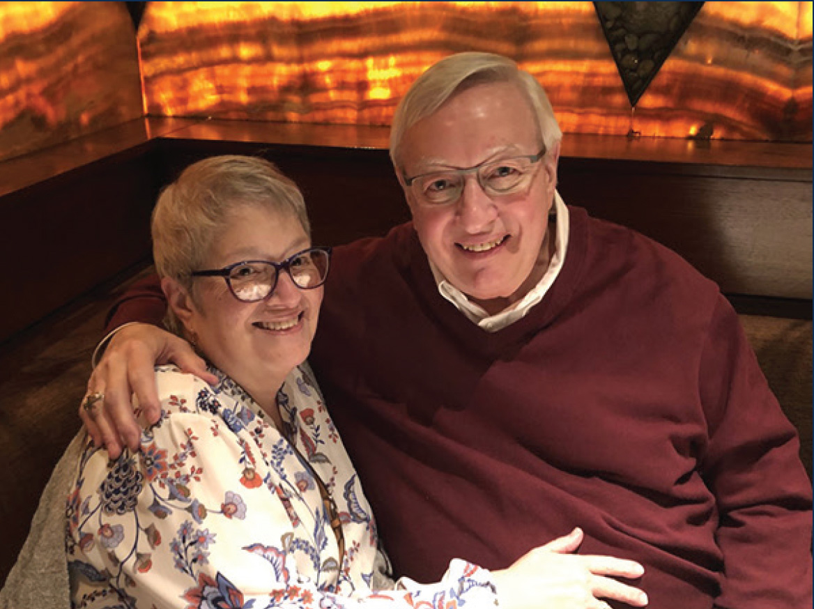 Older couple smiling and posing for a picture