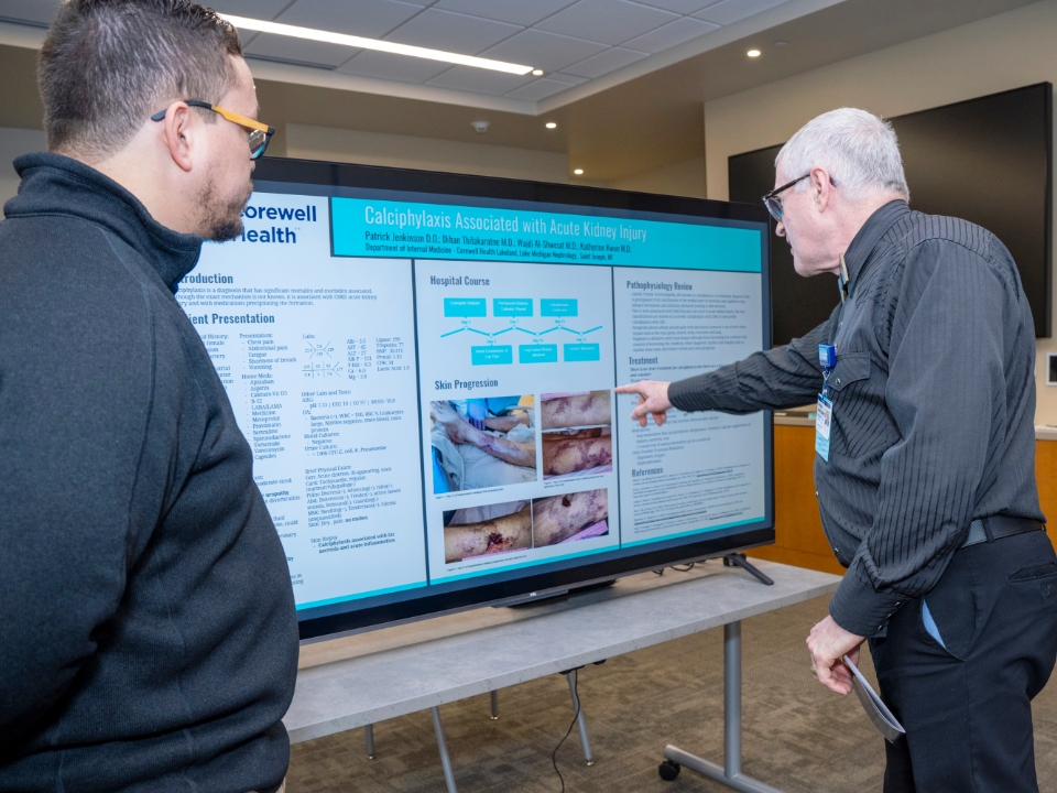 two people reviewing something on a monitor at the research institute 