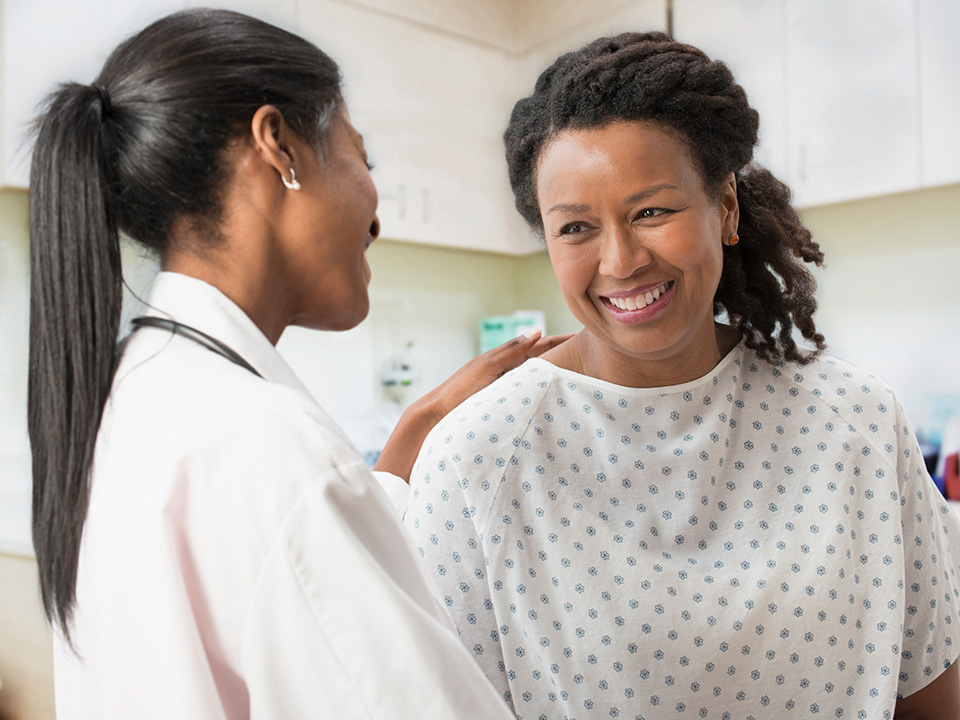Corewell Health breast care specialist speaks with a female patient before she has a mammogram