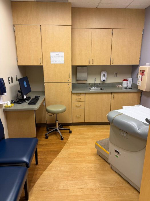 Photo of an actual exam room in the Troy Hospital complete with exam table, doctors stool and chairs
