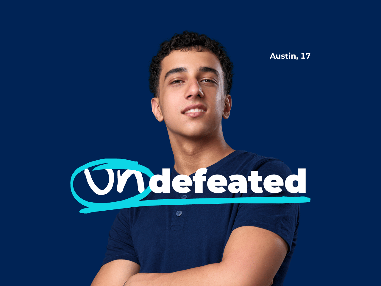 Preteen girl in a dark blue sweater standing with arms folded in front of dark blue background