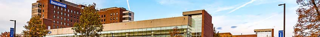 Corewell Health Dearborn Hospital with a blue sign, recognized as a vital trauma center for the Southwest Detroit community.