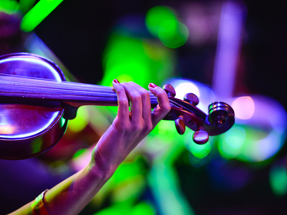 Colorful photo showing a musician playing a violin