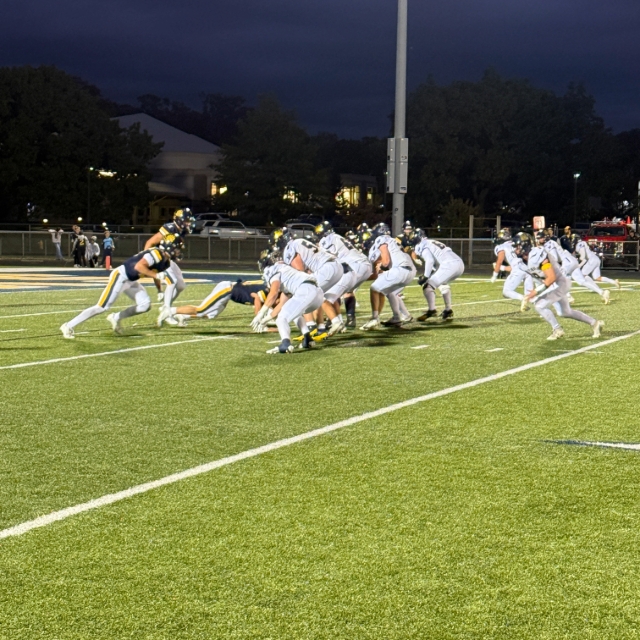 Football teams on field playing a game