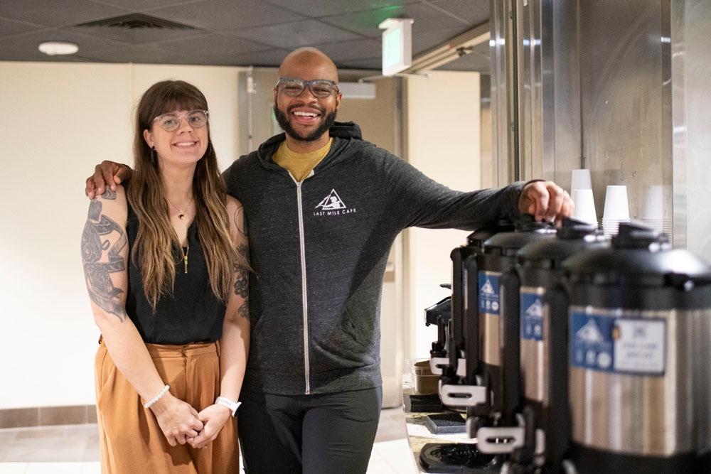 Arick and Sarah Davis standing next to a row of coffee carafes